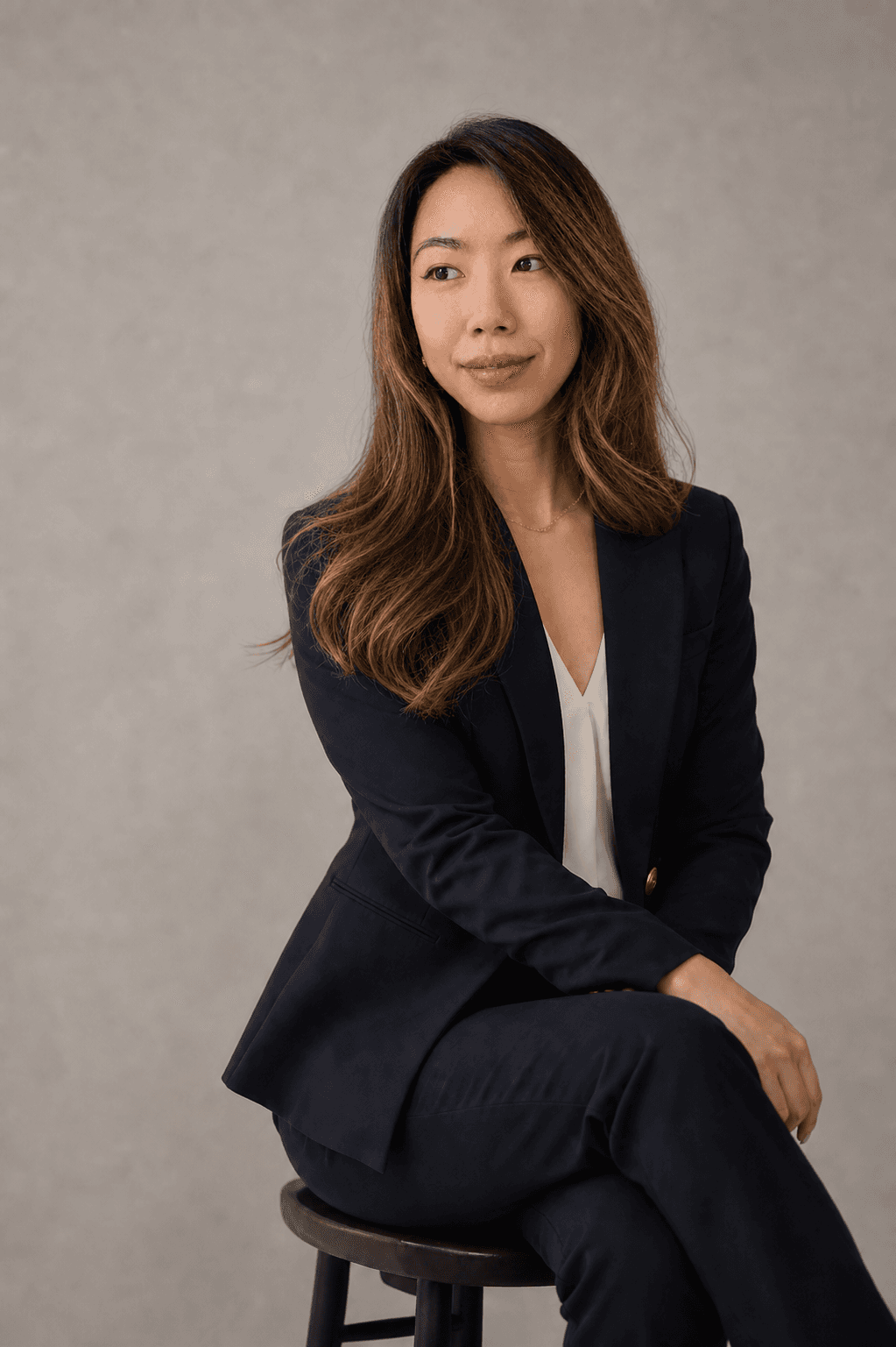 Hillary Lin, MD seated in a navy suit for a studio portrait