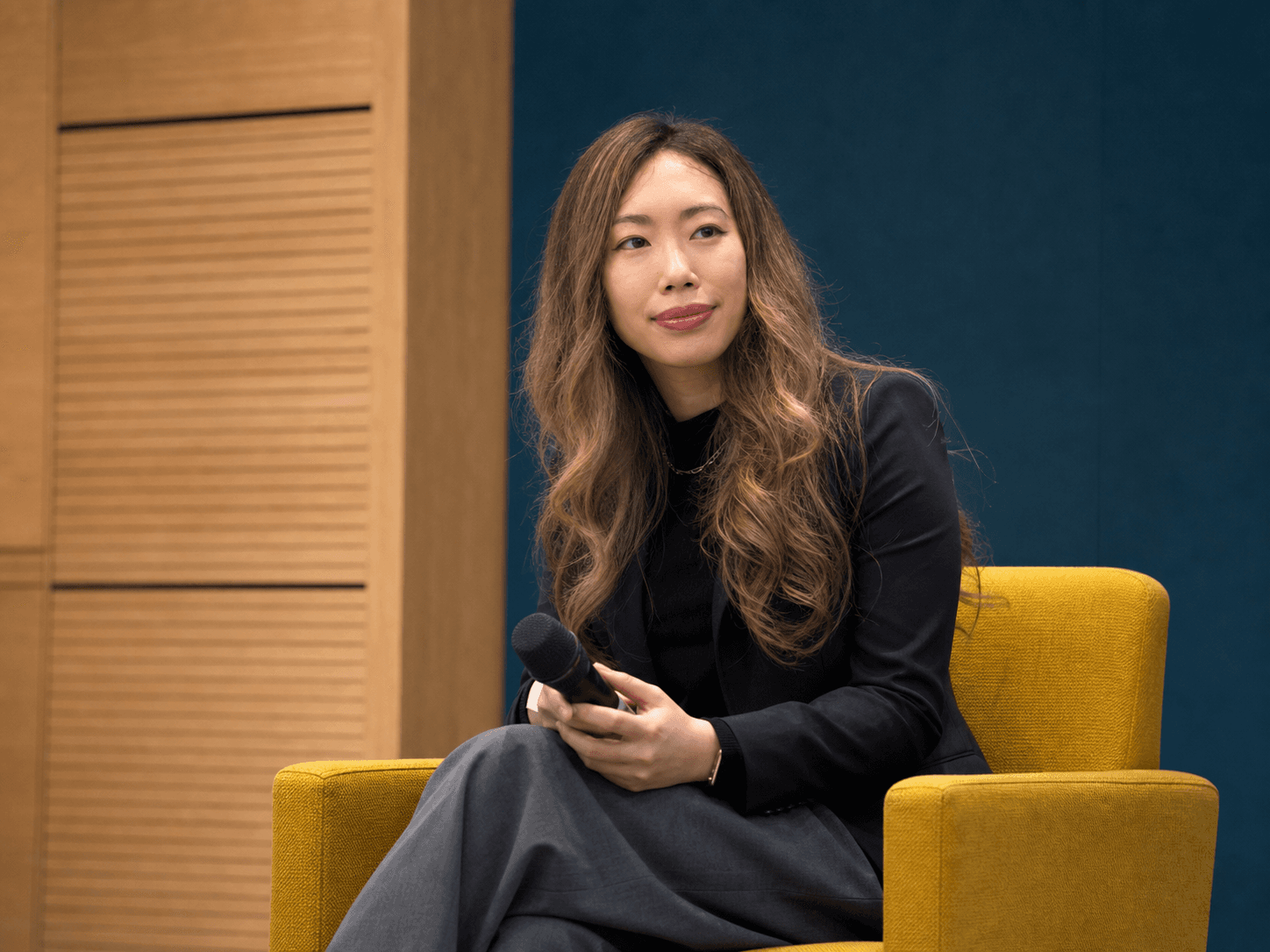 Hillary Lin, MD seated onstage with a microphone