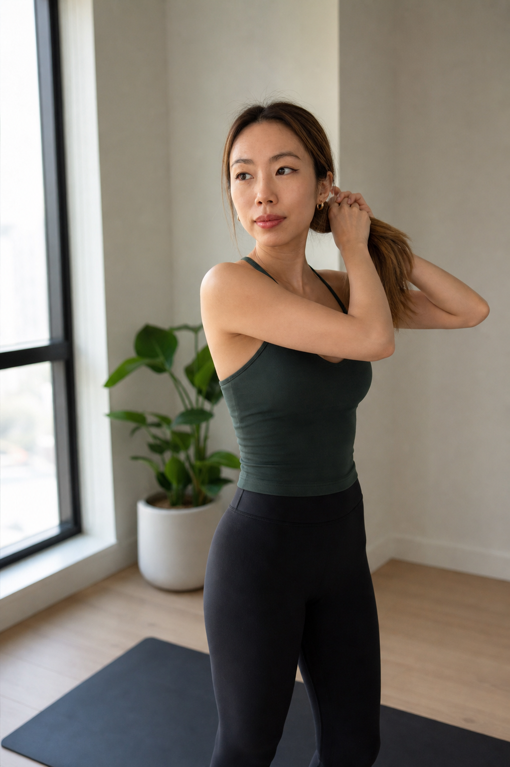 Hillary Lin, MD standing in activewear in a wellness studio